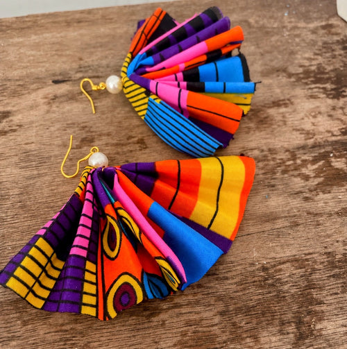 Adire Fan Earrings – pair on wooden surface